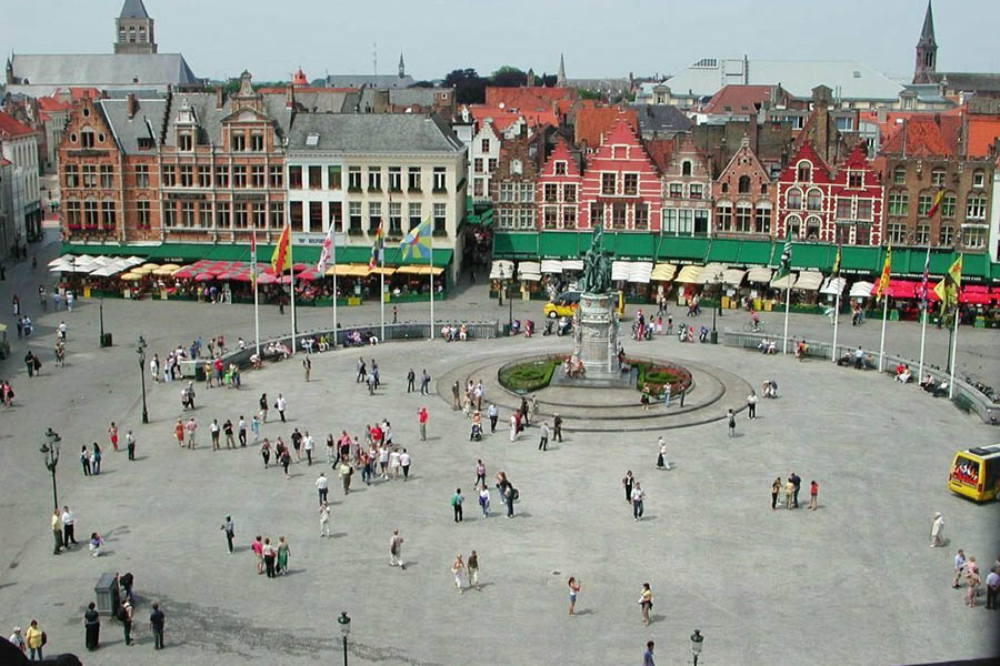 Bruges, Belgium: June 18, 2006: the Market Square view from the Belfort. Since 2000 the historic center of Bruges was declared World Heritage by UNESCO