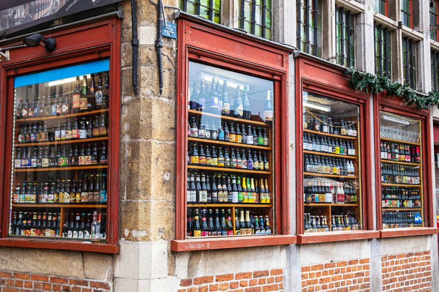 Ghent, Belgium - June 03, 2017: Traditional Belgian bottled beer in windows of a small shop in Ghent